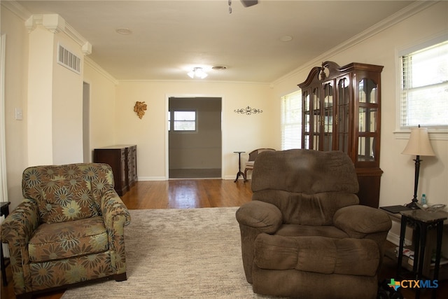 living room with hardwood / wood-style flooring and ornamental molding