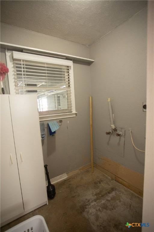 laundry room featuring a textured ceiling