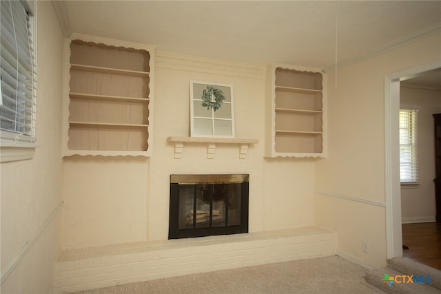 unfurnished living room with a fireplace, carpet flooring, and crown molding