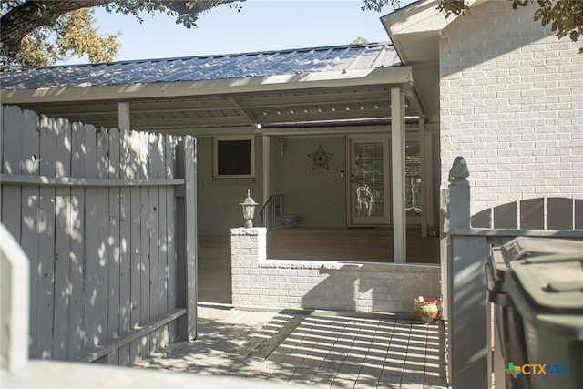 view of exterior entry with a carport