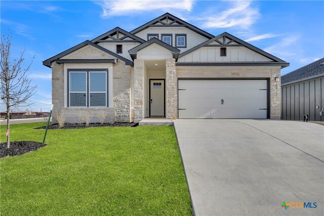 view of front facade with a garage and a front lawn