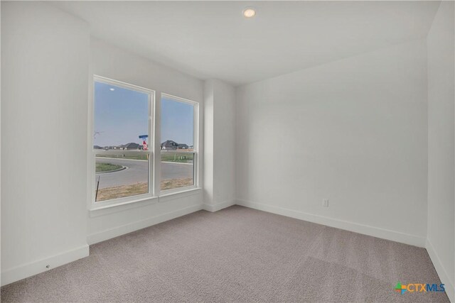 empty room with ceiling fan and carpet flooring