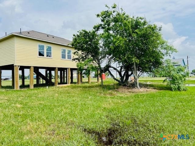 back of house with a lawn