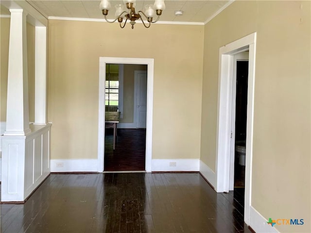 114 N Market St, Goliad, TX 77963 - unfurnished dining area featuring hardwood / wood-style floors, ornamental molding, and a chandelier
