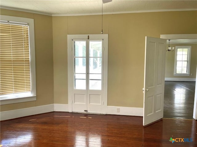 114 N Market St, Goliad, TX 77963 - spare room with hardwood / wood-style flooring, crown molding, and a chandelier
