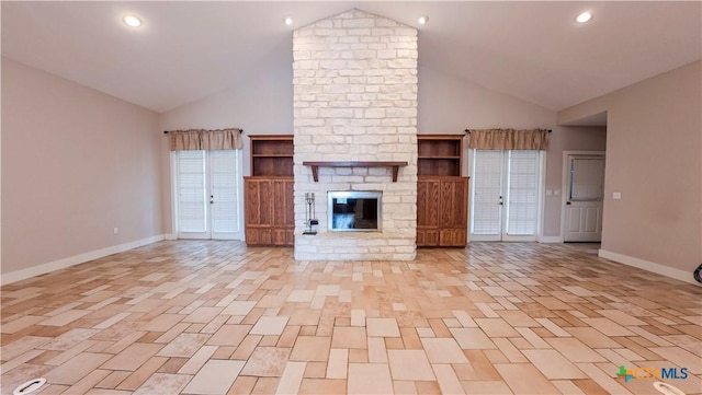 unfurnished living room with baseboards, high vaulted ceiling, and a fireplace
