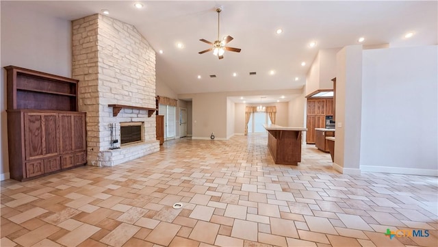 unfurnished living room with ceiling fan, a stone fireplace, baseboards, and high vaulted ceiling