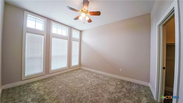 unfurnished room featuring baseboards, carpet flooring, and ceiling fan