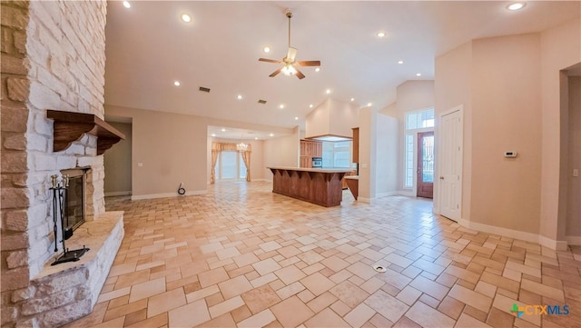 unfurnished living room with a fireplace, high vaulted ceiling, a ceiling fan, recessed lighting, and baseboards