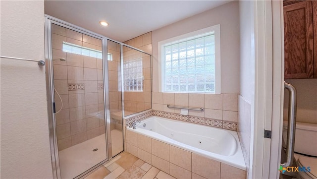 full bath with a jetted tub, recessed lighting, and a shower stall