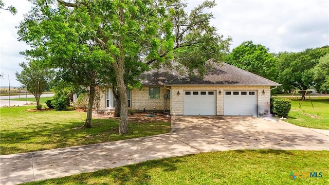 view of front of house with a garage, driveway, a front lawn, and stone siding