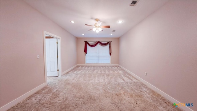unfurnished room featuring ceiling fan, light colored carpet, recessed lighting, baseboards, and visible vents