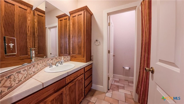 bathroom featuring vanity and baseboards