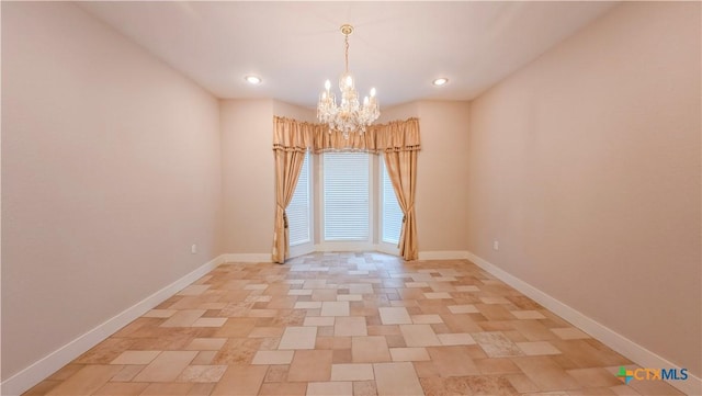 unfurnished room featuring an inviting chandelier, recessed lighting, and baseboards