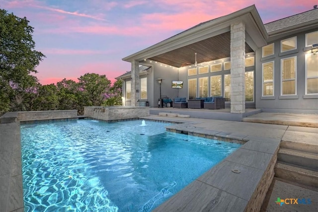 292 Scenic Cyn, New Braunfels, TX 78132 - pool at dusk featuring a ceiling fan, an outdoor pool, a patio, and an outdoor hangout area