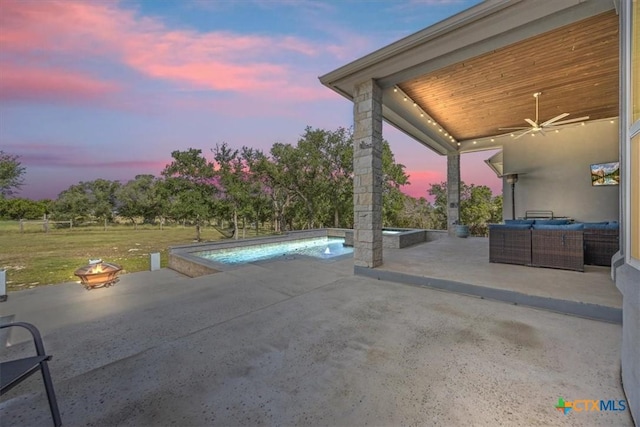 292 Scenic Cyn, New Braunfels, TX 78132 - pool at dusk with a patio area, a ceiling fan, an outdoor living space with a fire pit, and an outdoor pool
