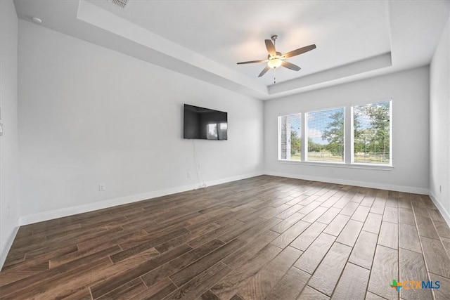 292 Scenic Cyn, New Braunfels, TX 78132 - spare room featuring a raised ceiling, dark wood-style flooring, and a ceiling fan