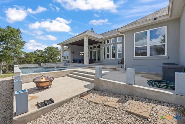 292 Scenic Cyn, New Braunfels, TX 78132 - back of property featuring a fire pit, a patio, and stucco siding