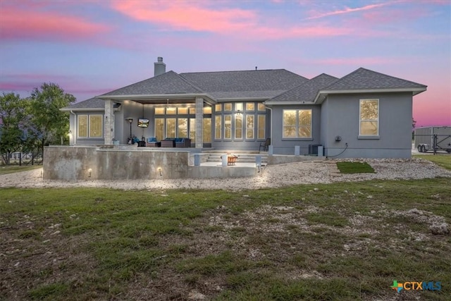 292 Scenic Cyn, New Braunfels, TX 78132 - back of house with a chimney, a yard, a patio area, and roof with shingles