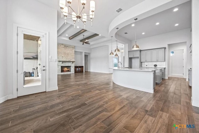 292 Scenic Cyn, New Braunfels, TX 78132 - kitchen featuring gray cabinetry, dark wood finished floors, open floor plan, a chandelier, and recessed lighting