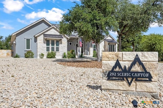 292 Scenic Cyn, New Braunfels, TX 78132 - view of front of property with stone siding, a standing seam roof, a metal roof, and stucco siding