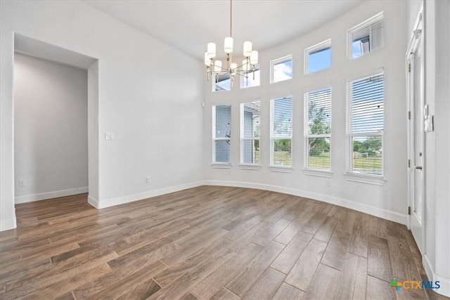 292 Scenic Cyn, New Braunfels, TX 78132 - unfurnished dining area featuring a chandelier and wood finished floors