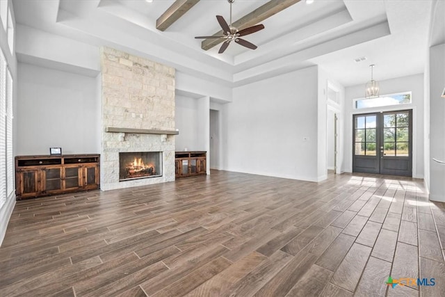 292 Scenic Cyn, New Braunfels, TX 78132 - unfurnished living room with a raised ceiling, dark wood-type flooring, ceiling fan, and a fireplace
