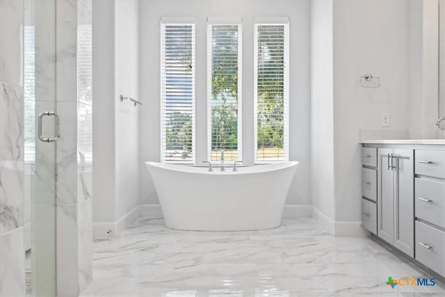 292 Scenic Cyn, New Braunfels, TX 78132 - full bathroom with marble look tile flooring, vanity, a freestanding tub, and a marble finish shower