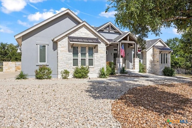 292 Scenic Cyn, New Braunfels, TX 78132 - view of front of house with stone siding, a standing seam roof, a metal roof, and stucco siding