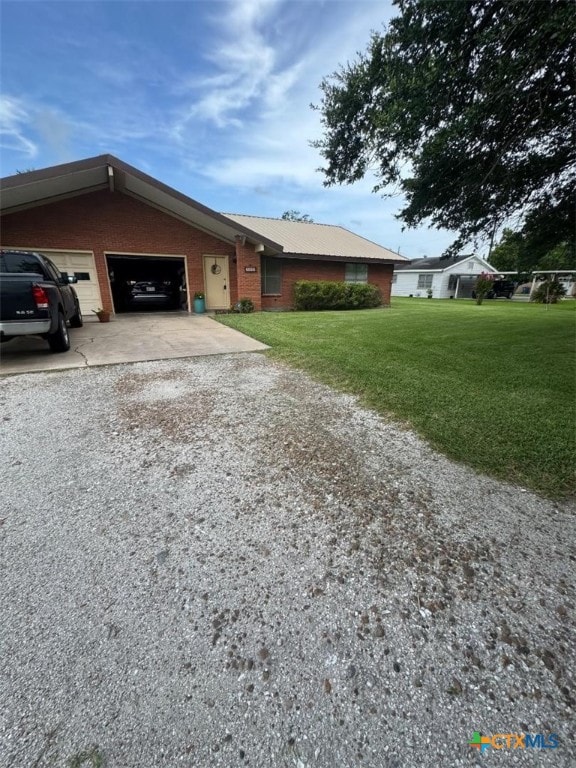 1608 S Virginia St, Port Lavaca, TX 77979 - single story home featuring driveway, a front lawn, an attached garage, and brick siding