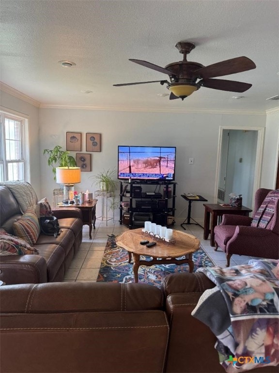 1608 S Virginia St, Port Lavaca, TX 77979 - living area with crown molding, a ceiling fan, a textured ceiling, and light tile patterned floors