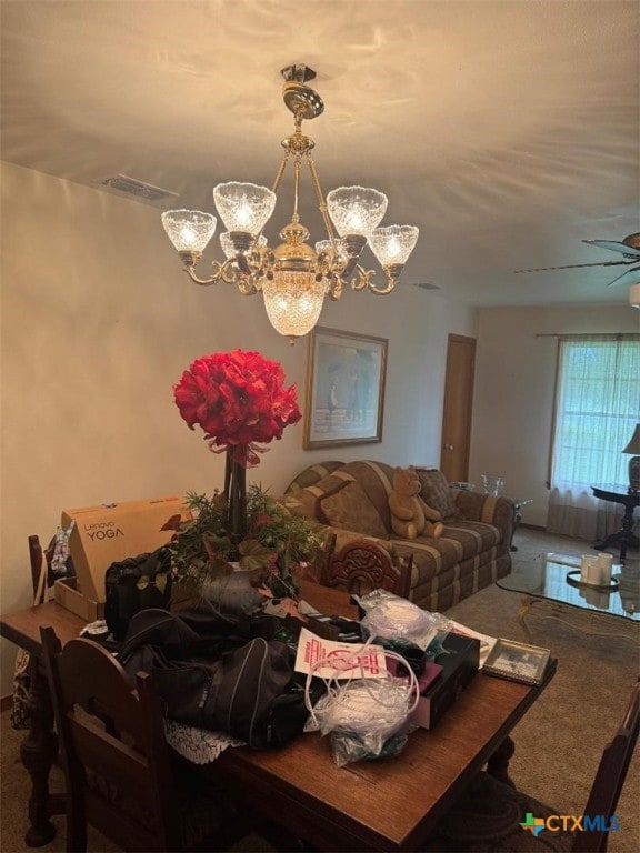 1608 S Virginia St, Port Lavaca, TX 77979 - carpeted dining space with a chandelier