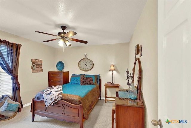 bedroom with light carpet and ceiling fan