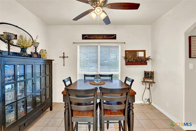 dining room with ceiling fan and light tile patterned flooring