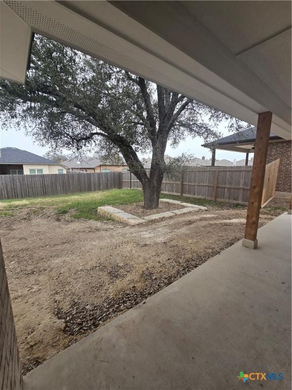 view of yard featuring a patio area and a fenced backyard