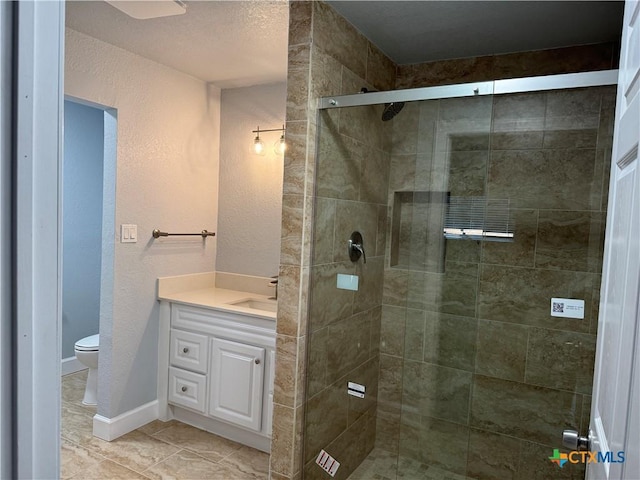 bathroom featuring walk in shower, tile patterned flooring, vanity, and toilet