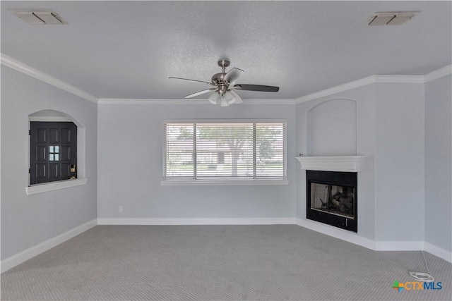 unfurnished living room with a textured ceiling, light colored carpet, ceiling fan, and crown molding