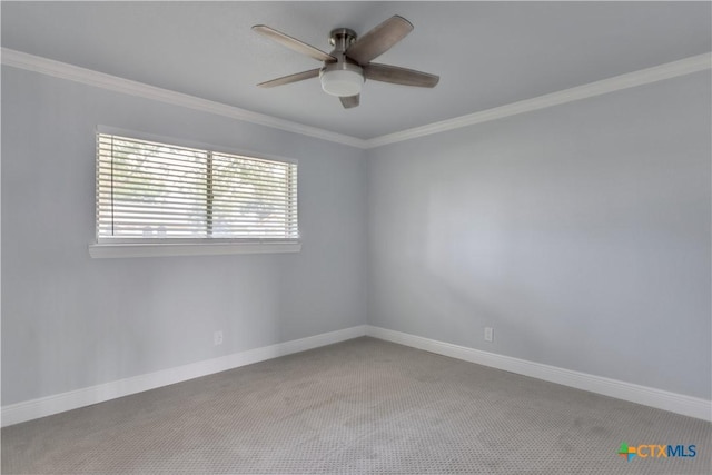 carpeted empty room with ceiling fan and crown molding