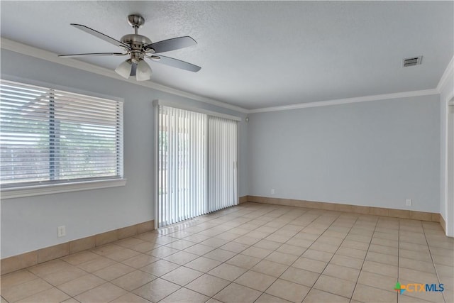 spare room featuring a textured ceiling, ceiling fan, light tile patterned floors, and ornamental molding