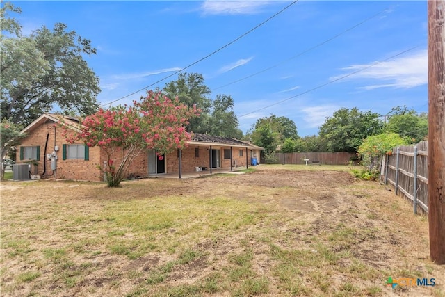 view of yard with a patio and central AC unit