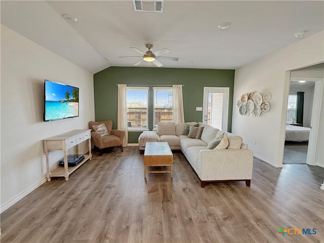 living room with lofted ceiling, light hardwood / wood-style flooring, and ceiling fan