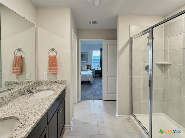 bathroom featuring tile patterned flooring, vanity, and an enclosed shower