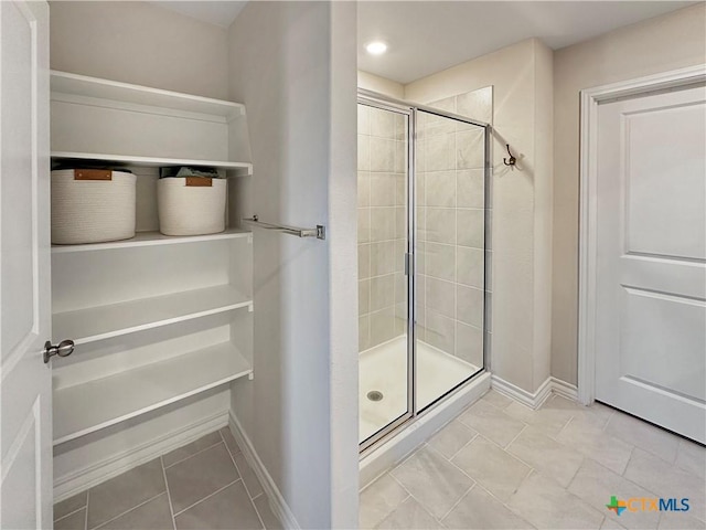 bathroom featuring tile patterned floors and an enclosed shower