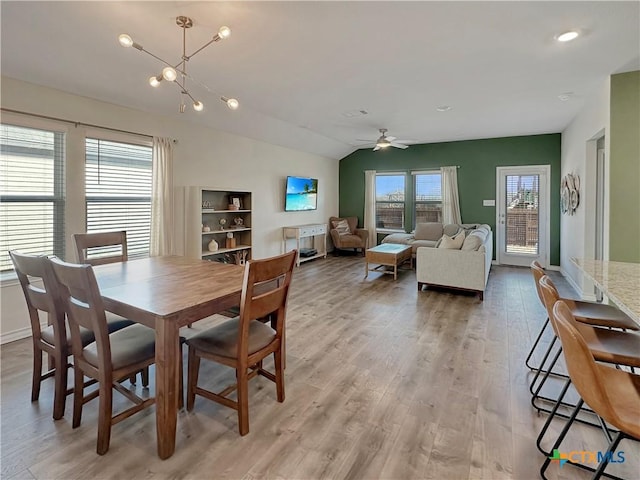 dining space with lofted ceiling, light hardwood / wood-style floors, and ceiling fan