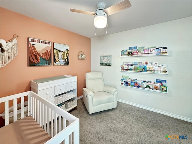 bedroom with carpet floors, a crib, and ceiling fan