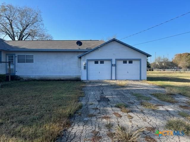 exterior space with a garage and a front yard