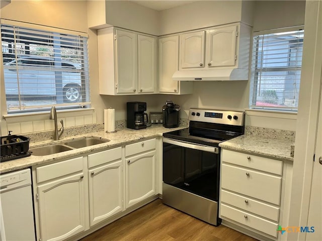 kitchen featuring sink, white cabinetry, stainless steel electric range oven, white dishwasher, and light hardwood / wood-style floors