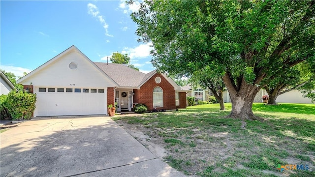 4108 Red River Cir, Temple, TX 76504 - view of front of house with a garage, brick siding, concrete driveway, and a front lawn