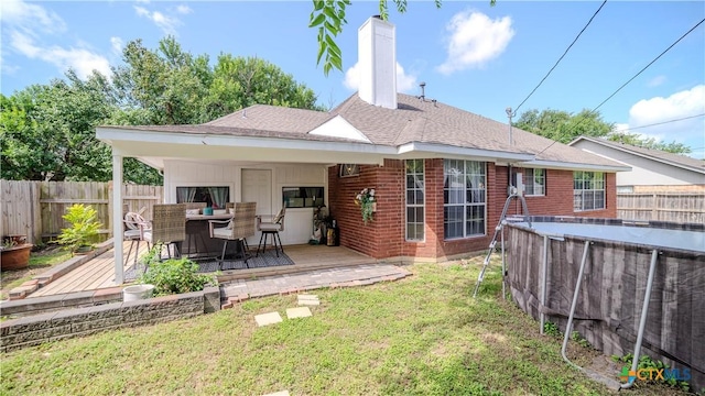 4108 Red River Cir, Temple, TX 76504 - back of property featuring a deck, a fenced backyard, brick siding, and roof with shingles