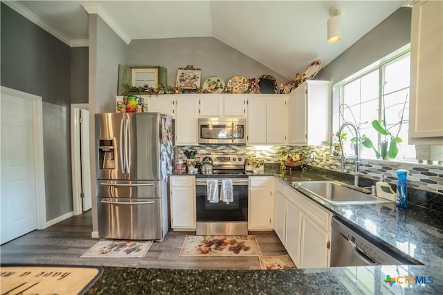 4108 Red River Cir, Temple, TX 76504 - kitchen with appliances with stainless steel finishes, tasteful backsplash, white cabinets, lofted ceiling, and wood finished floors